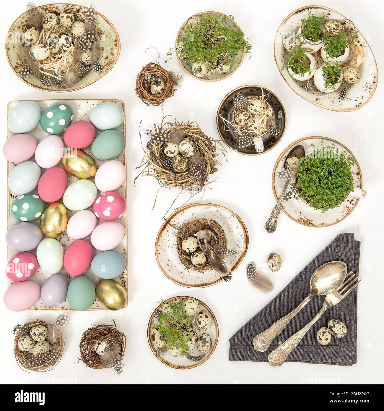 Easter flat lay top view. Festive table place setting decoration with colored eggs Stock Photo