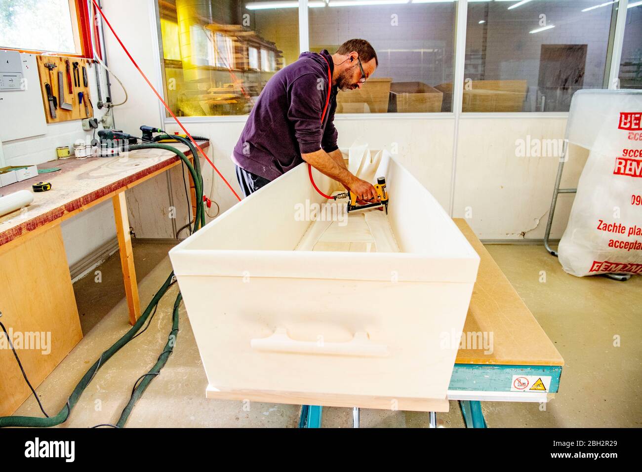 Gendringe, Netherlands. 23rd Apr, 2020. An employee making a casket at Tomba coffin maker.As the Coronavirus pandemic ravages Netherlands one coffin design firm south of Gendering has been busy delivering hundreds of caskets per week to double the usual production capacity. Coffin makers and the funeral industry at large are working hard. Credit: SOPA Images Limited/Alamy Live News Stock Photo