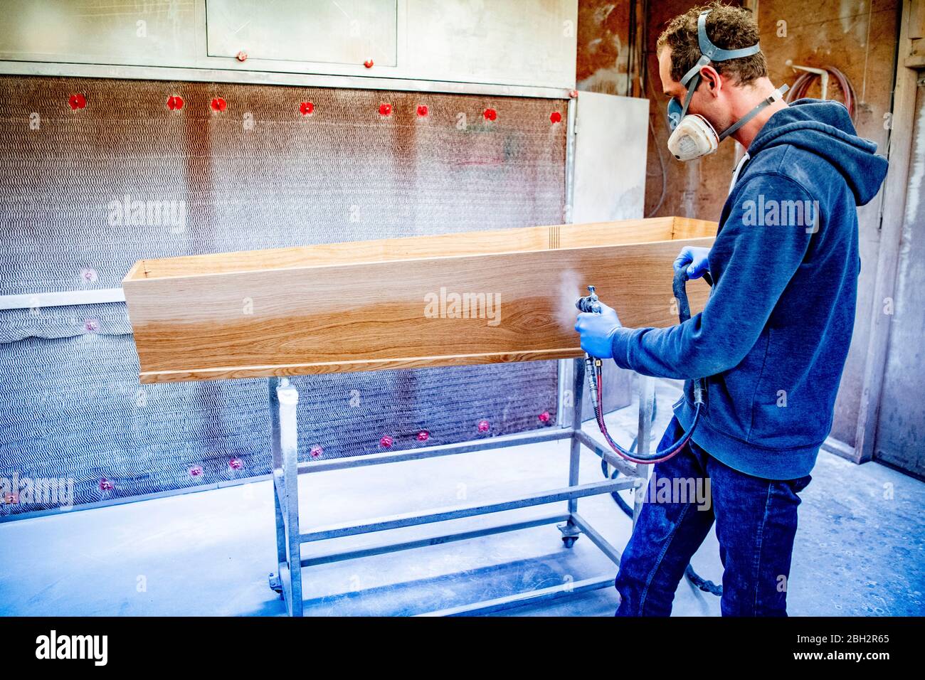 Gendringe, Netherlands. 23rd Apr, 2020. An employee makes a casket while wearing a face mask against Coronavirus as a preventive measure at Tomba coffin maker.As the Coronavirus pandemic ravages Netherlands one coffin design firm south of Gendering has been busy delivering hundreds of caskets per week to double the usual production capacity. Coffin makers and the funeral industry at large are working hard. Credit: SOPA Images Limited/Alamy Live News Stock Photo