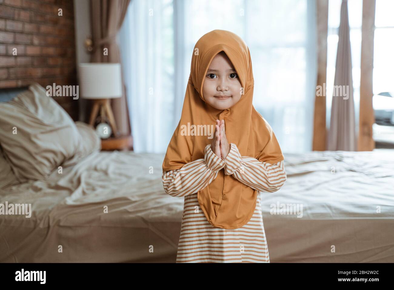 cute muslim girl greeting gesture welcoming ramadan Stock Photo