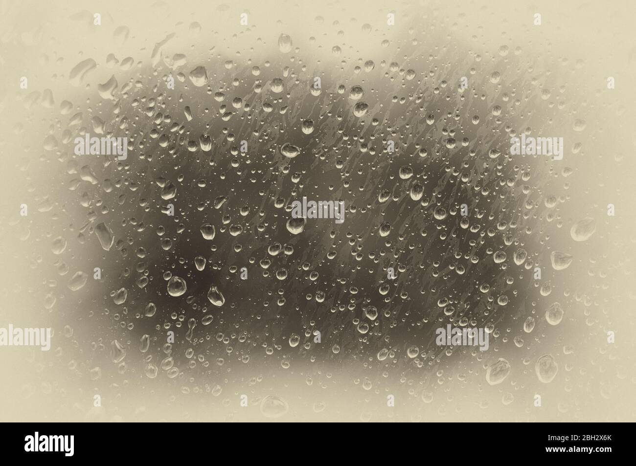 Drops of water on the misted glass. Toned photo, soft focus. Original vintage background with vignetting Stock Photo