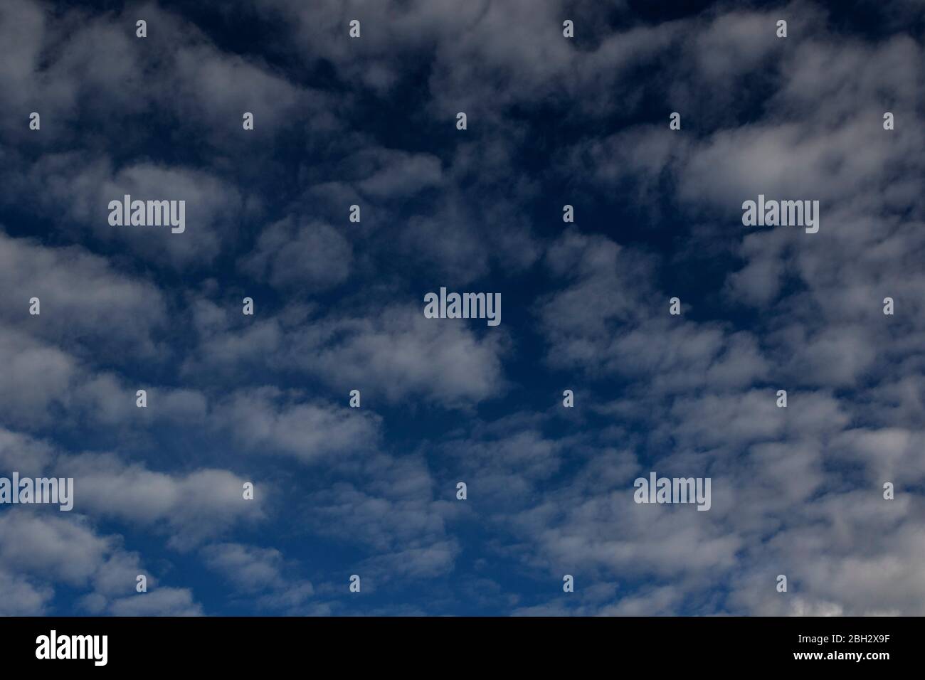 White clouds stacked up against a blue sky Stock Photo