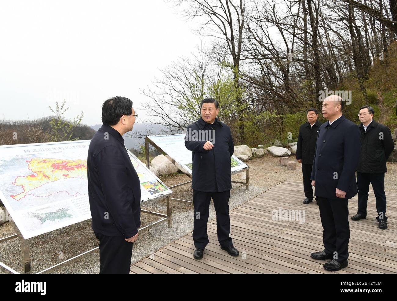 (200423) -- XI'AN, April 23, 2020 (Xinhua) -- Chinese President Xi Jinping, also general secretary of the Communist Party of China Central Committee and chairman of the Central Military Commission, learns about ecological conservation of the Qinling Mountains at Niubeiliang National Nature Reserve, northwest China's Shaanxi Province, April 20, 2020. Xi urged local officials in Shaanxi to learn their lesson the hard way from the illegal construction of villas in the Qinling Mountains, avoid repeating the same mistake and work as guardians of the ecological environment of Qinling. Xi made an ins Stock Photo