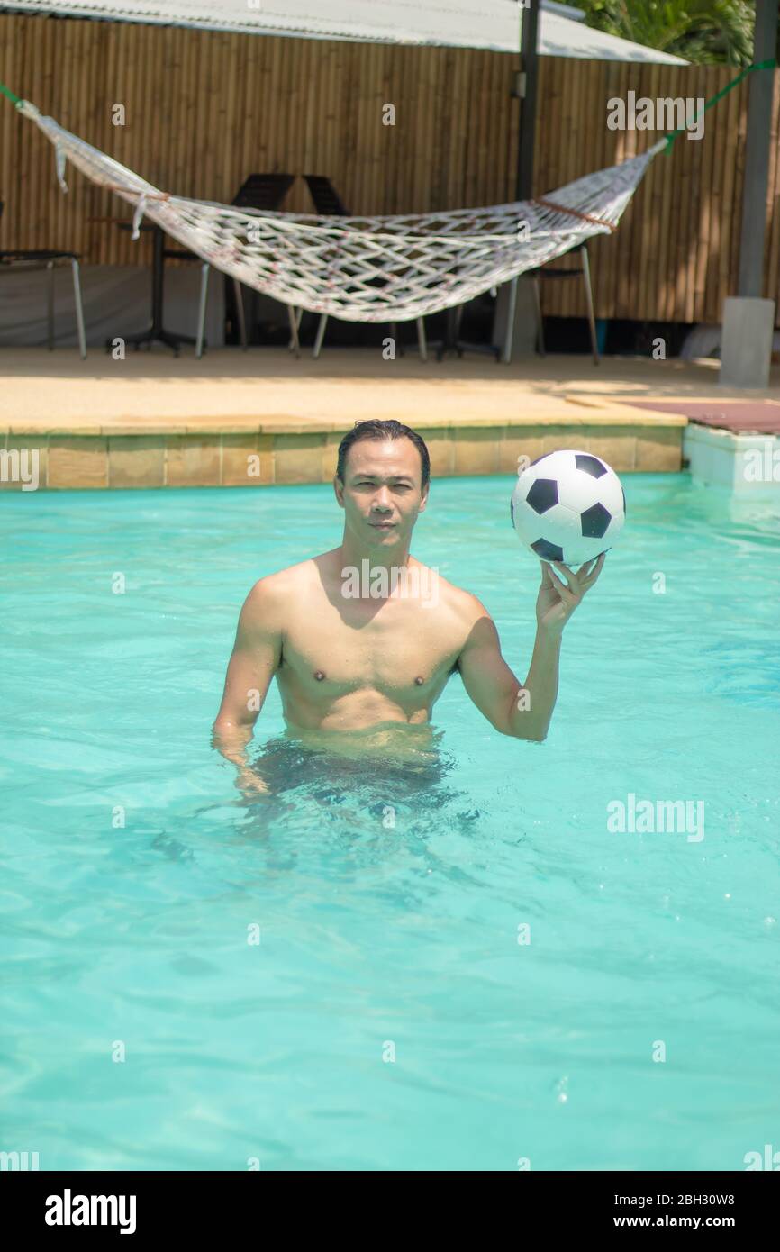 Men playing soccer ball in a swimming pool Stock Photo Alamy