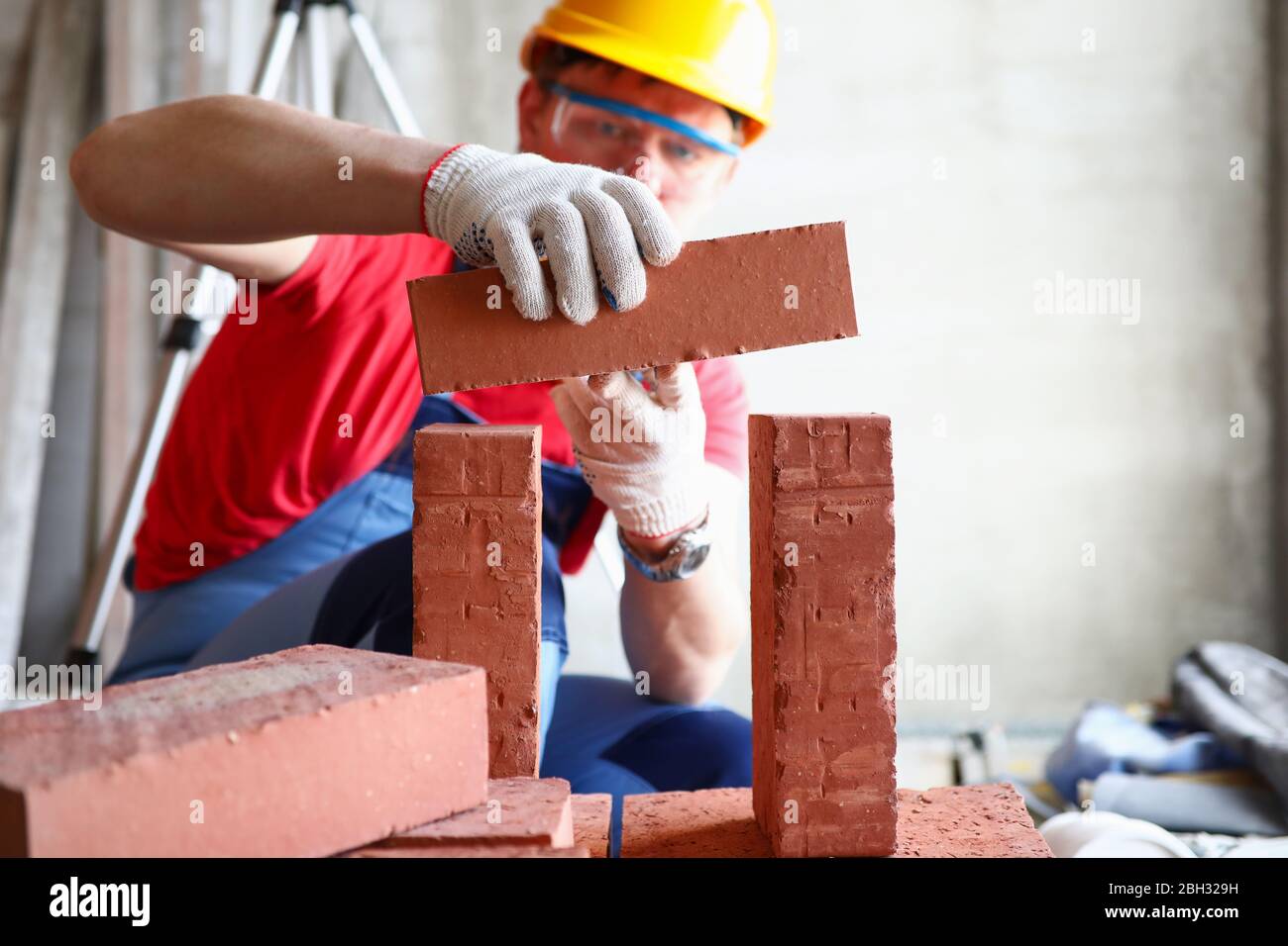 Male person constructing brickwall Stock Photo Alamy