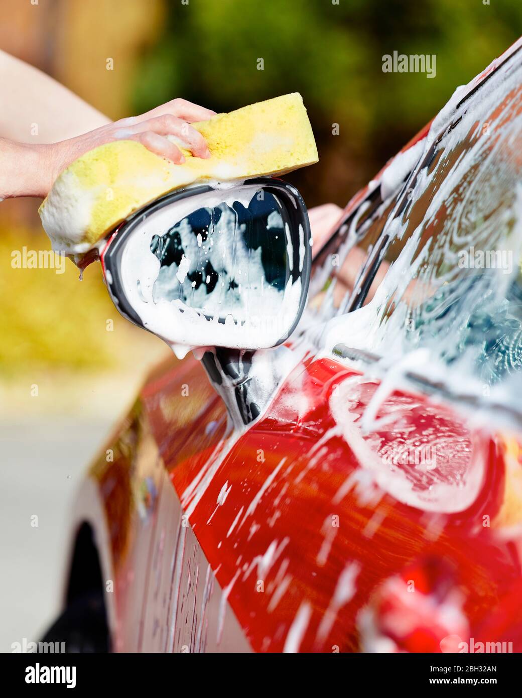 Woman washing her car Stock Photo Alamy