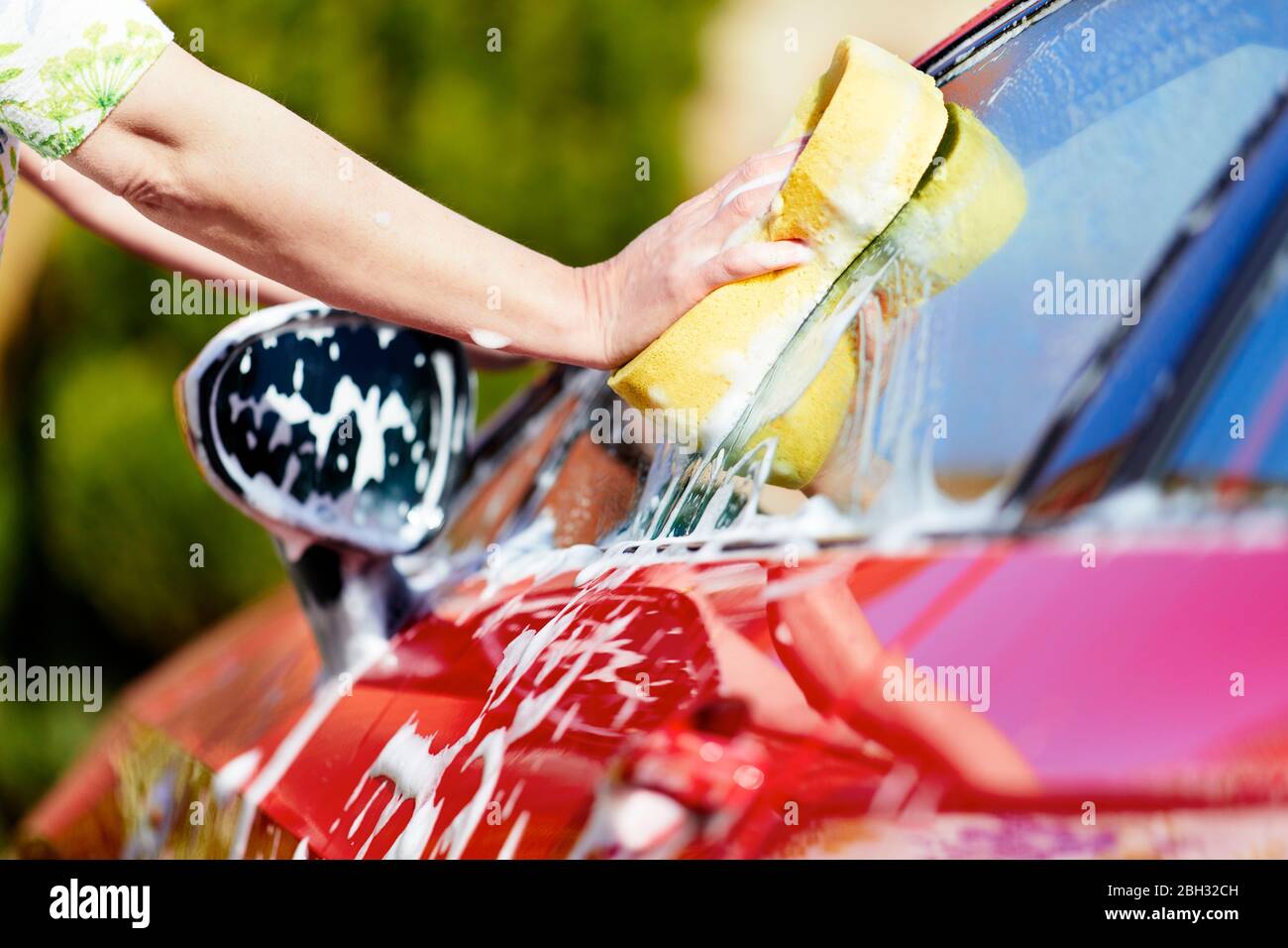 Woman washing her car Stock Photo