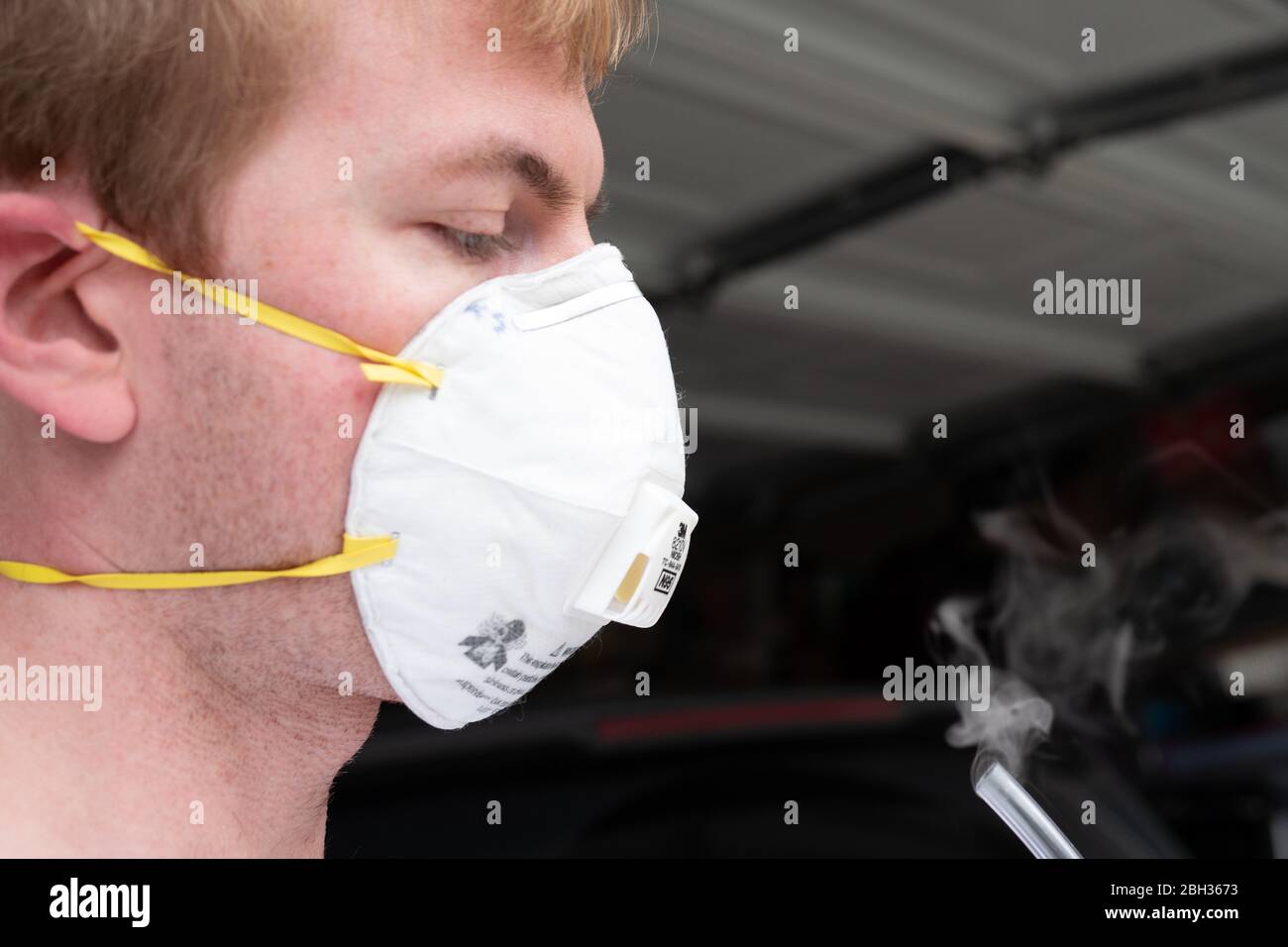 Allegro brand stannic chloride aspirator expelling vapor during fit test of N95 mask, San Ramon, California, with test subject's face visible, April 17, 2020. N95 masks are commonly used in the treatment of COVID-19 coronavirus by medical professionals, and are often fit tested before use with infectious patients. Stannic chloride is typically used for N100 masks, but is shown here for illustrative purposes. () Stock Photo