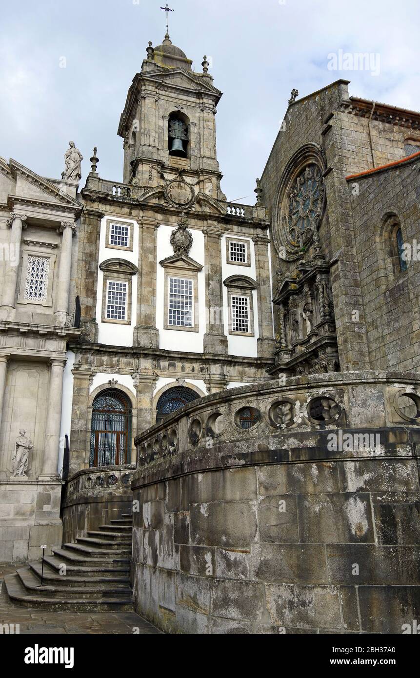 The Baroque façade and doorway to the late-Gothic church of St Francis, Porto, Portugal, a with a former conventual building (?) with a bell tower Stock Photo