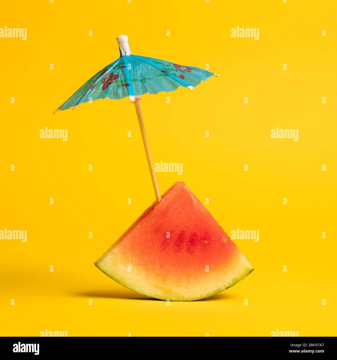 Watermelon and cocktail umbrella tropical summer background Stock Photo