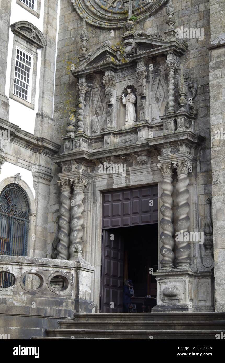 The 18th C Baroque entrance façade to the late-Gothic church of St Francis, Porto, Portugal, barley sugar columns, statue of St Francis above door Stock Photo