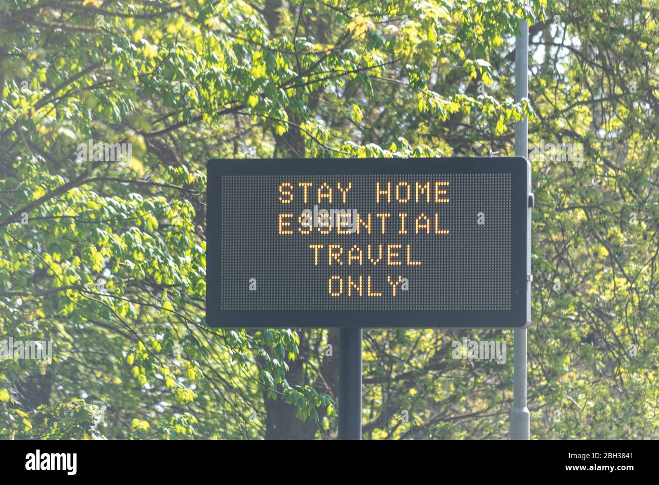 Traffic matrix sign beside A128 in Essex advising people to stay home, essential travel only, during COVID-19 Coronavirus pandemic lockdown period Stock Photo