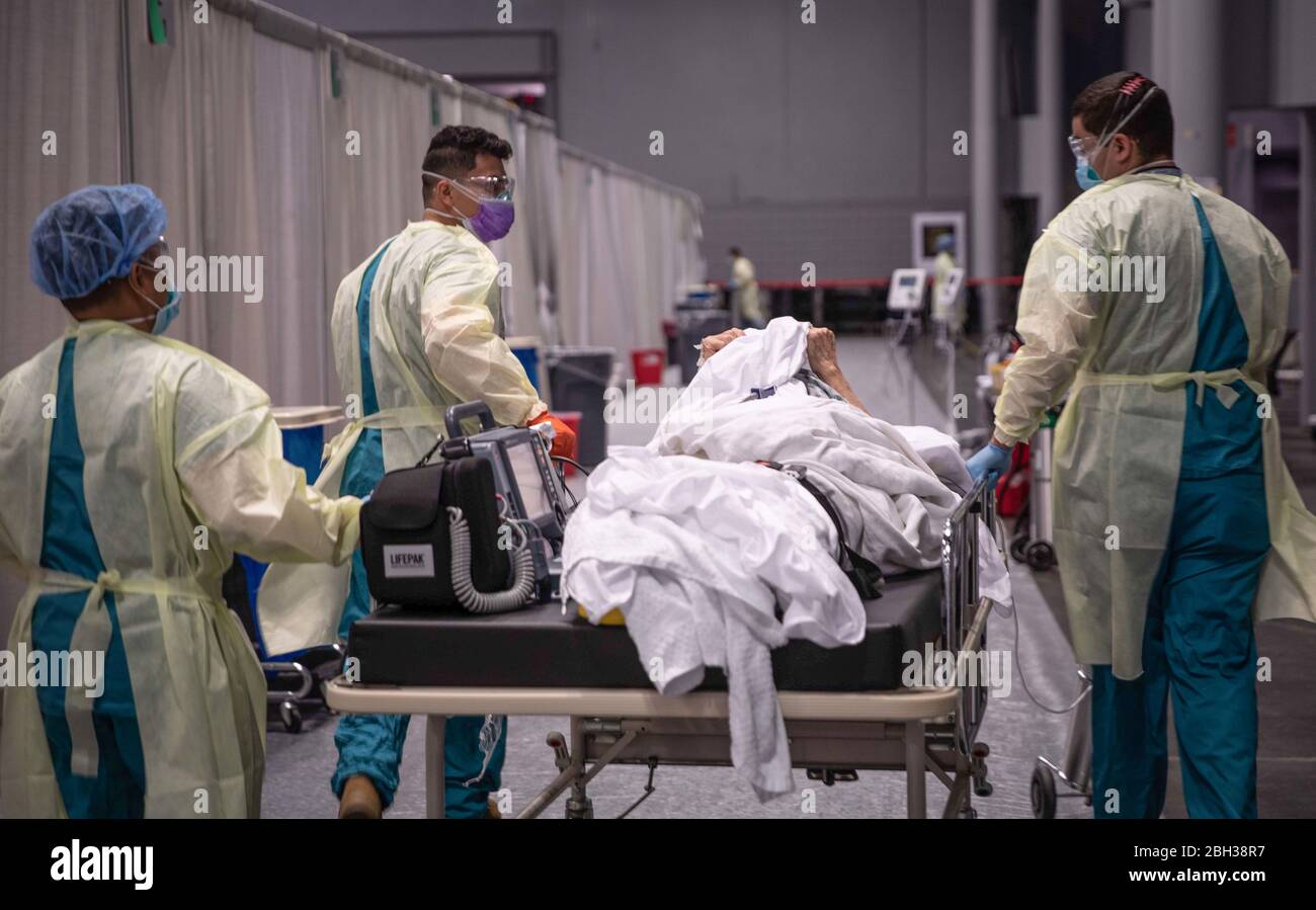 U.S. Army service members, deployed from Fort Campbell, Kentucky transport a patient to the Intensive Care Unit at the Javits New York Medical Station at Jacob K. Javits Convention Center in New York City, in support of the Department of Defense COVID-19 response. Stock Photo
