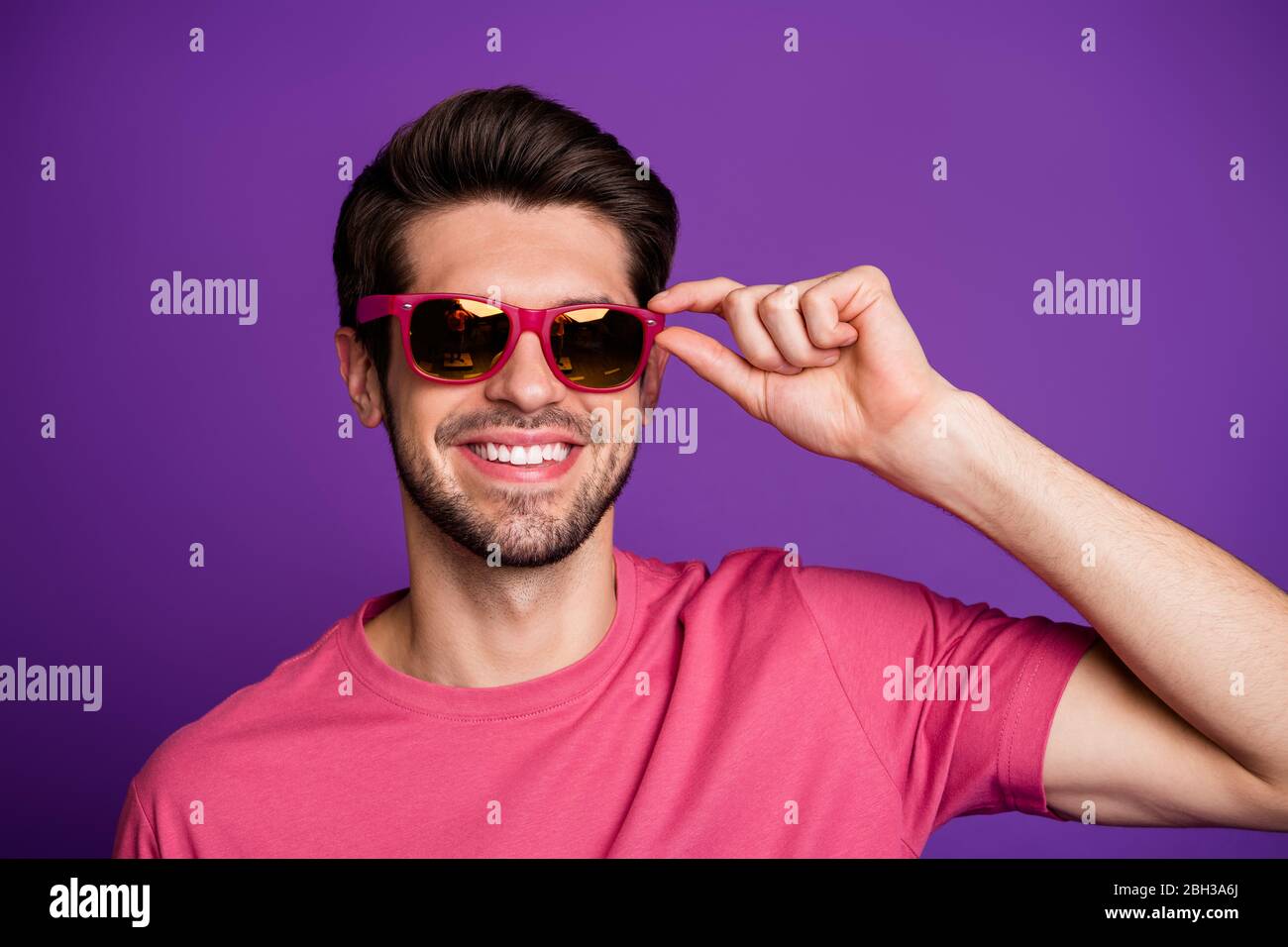 Portrait of positive candid macho man touch cool stylish specs look good attract beautiful women wear stylish clothes isolated over bright color Stock Photo