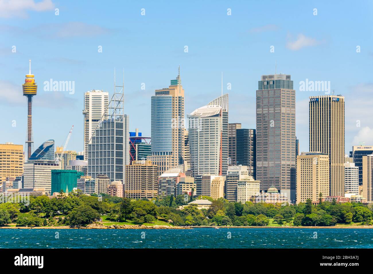 View of Sydney CBD on a sunny summer day with partly cloudy blue sky across Port Jackson. New South Wales, Australia. Stock Photo