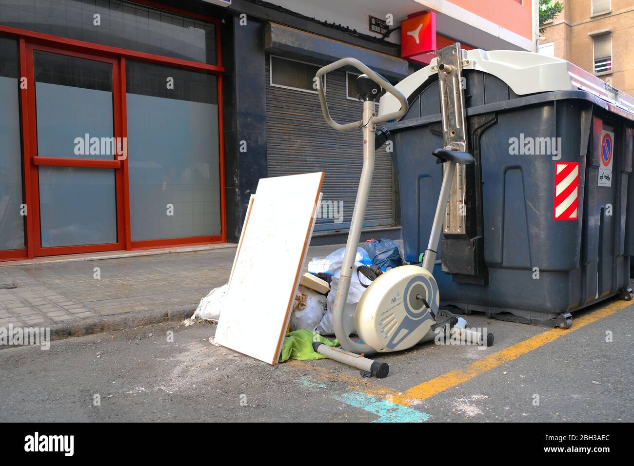 Discarded gym equipment, consumptionism and garbage disposal in a big city. Stock Photo