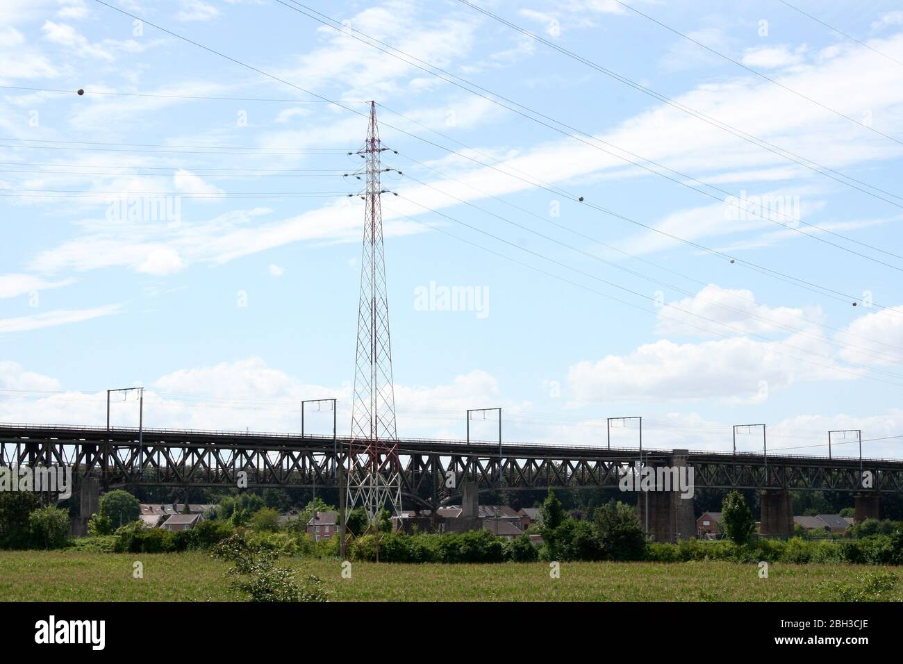 Large steel railway bridge, blue sky in the background Große stählerne Eisenbahnbrücke, blauer Himmel im Hintergrund Stock Photo