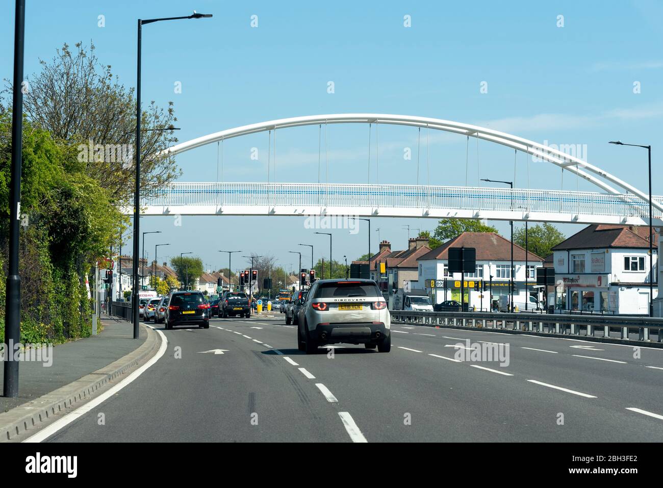 New white arc pedestrian footbridge over the A127 arterial road at the Kent Elms junction with A1015. Eastwood. Rayleigh road, Bridgewater Drive Stock Photo