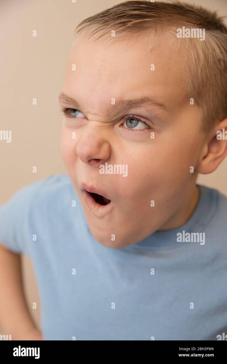 Young boy making a funny face while playing around Stock Photo