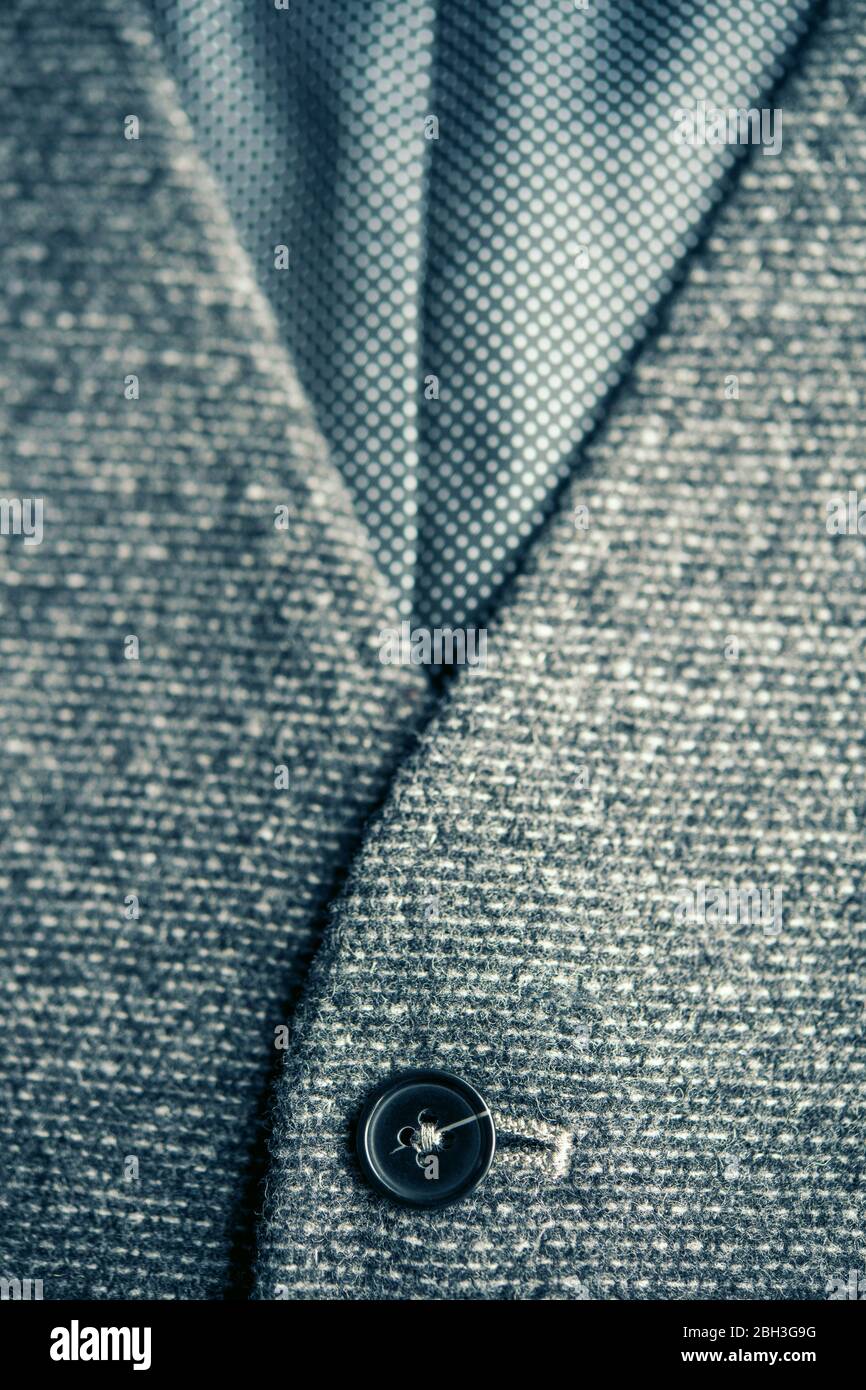 Detail of a men's grey waistcoat with the top button done up Stock Photo