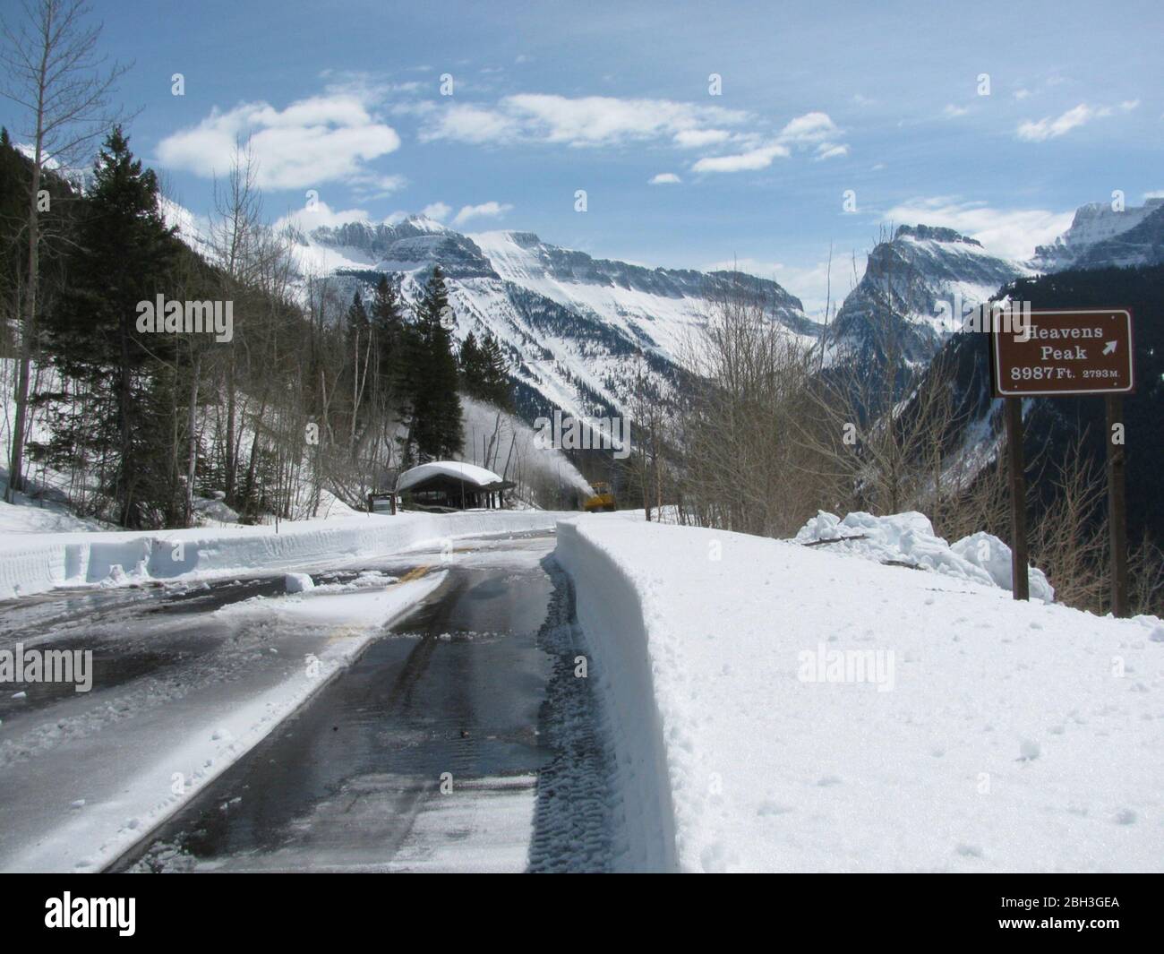 Snow removed from the Loop turnaround along the winding Going-To-The-Sun road at an elevation of 6,646 feet in Glacier National Park April 14, 2020 in Glacier, Montana. Road clearing continues despite the park being closed to visitors due to the COVID-19, coronavirus pandemic. Stock Photo