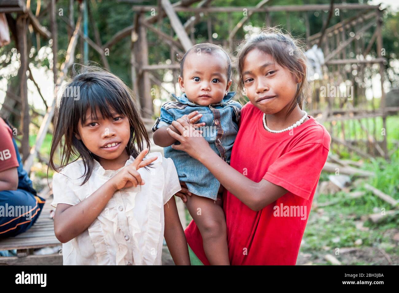 Young children pose for the camera in the floating village of Kampong Phluk, Cambodia, South East Asia. Stock Photo