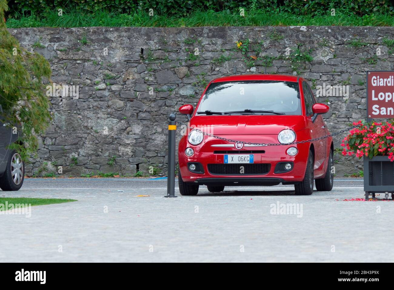 Lombardia, Italy - Sep. 30, 2019: Red Fiat 500, symbol of Italian cars. Fiat is a historical Italian car manufacturer. Stock Photo