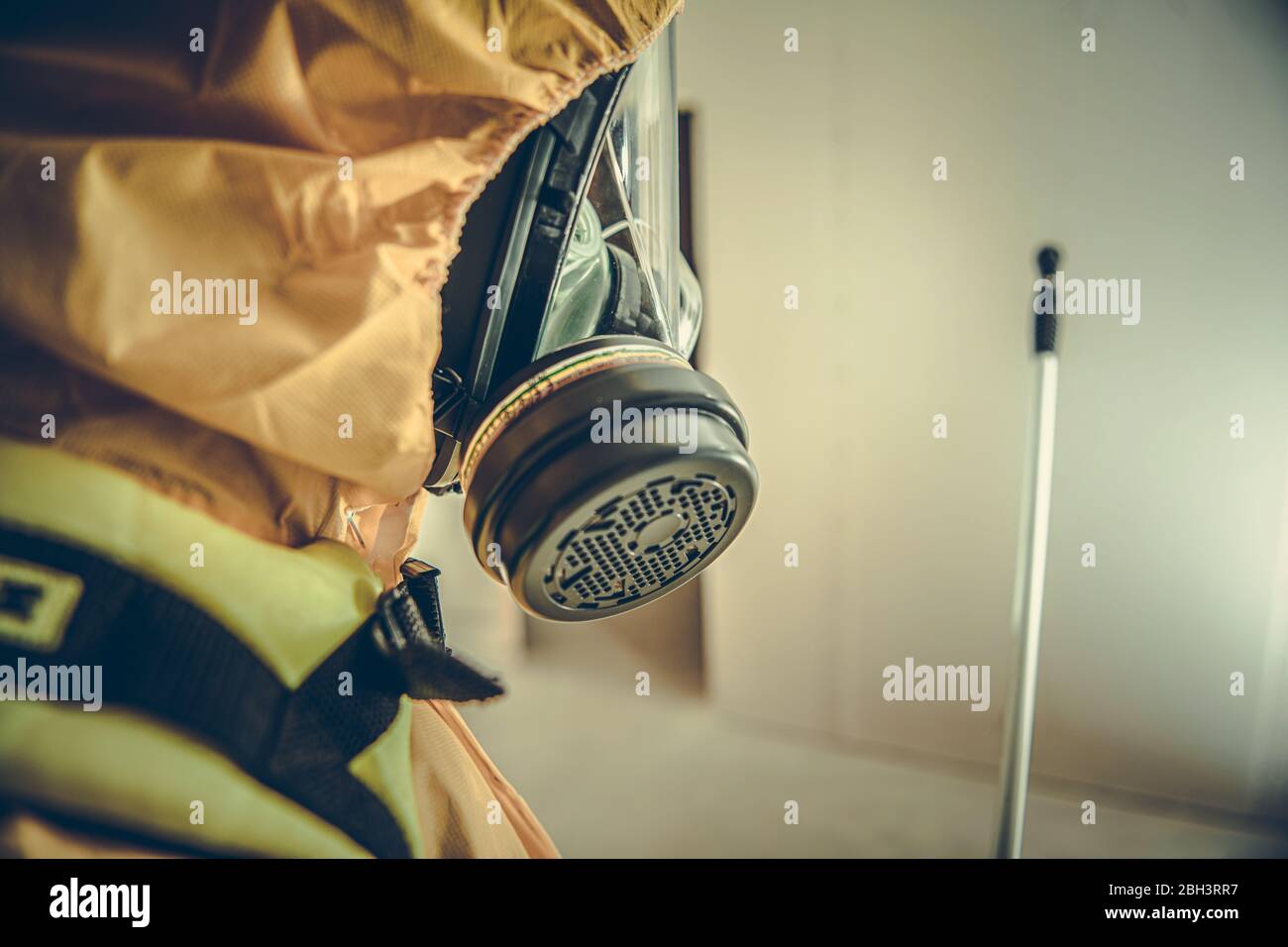 Close Up Of Worker In Hazmat Suit Mask And Spray Nozzle Cleaning Hazardous Waste. Stock Photo