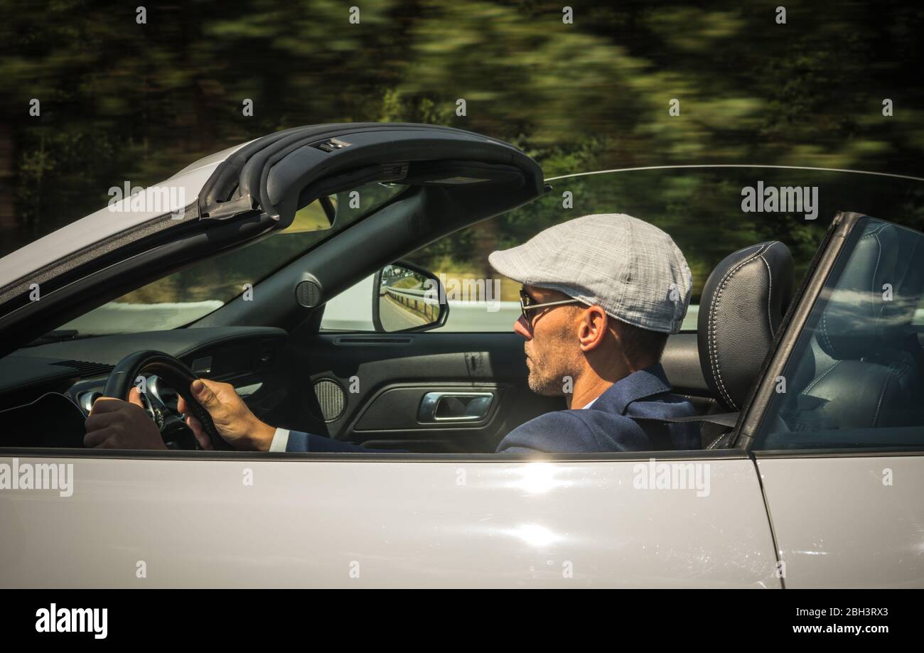 Wealthy Middle Age Man Driving Convertible Car. Stock Photo
