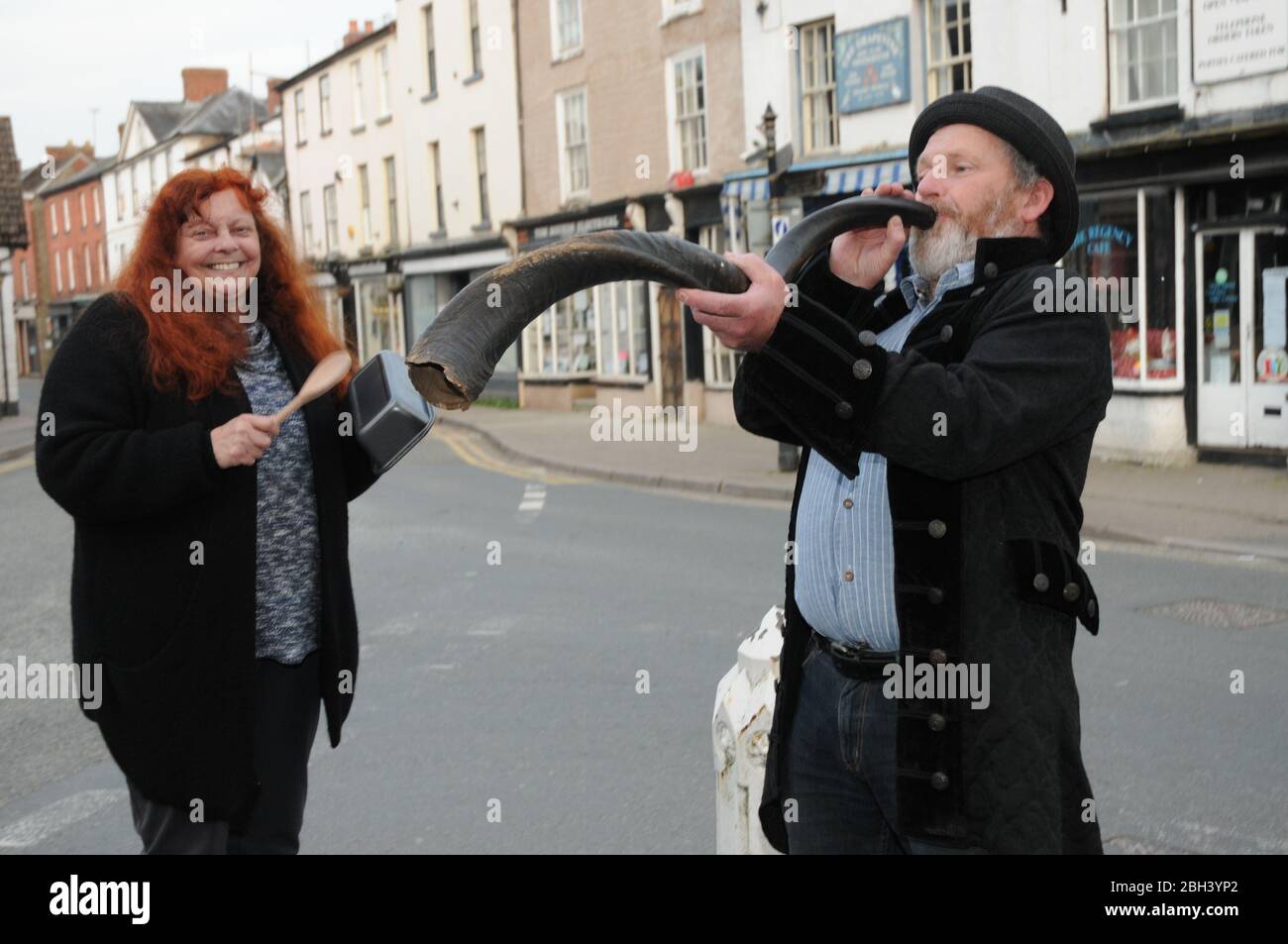 Kington, Herefordshire, UK. 23rd Apr, 2020. Kington resident Mark Jackson plays a Kudo horn in the town's High Street. A kudu horn is from an animal called a Kudu which is a species of antelope. Mark plays the instrument alongside wife Sandy to show support for key workers during the 'Clap for Carers' campaign during the Coronavirus/ Covid 19 Pandemic. Credit: Andrew Compton/Alamy Live News Stock Photo