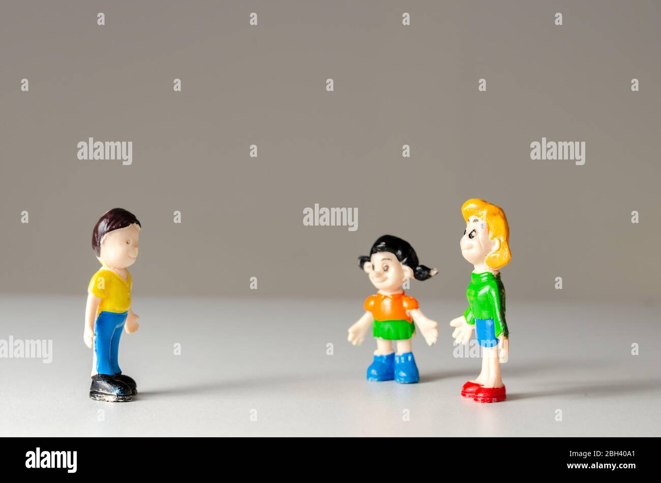 Toys figurines man and woman talking from a distance for fear of coronavirus contamination. Prevention of disease transmission . Stock Photo