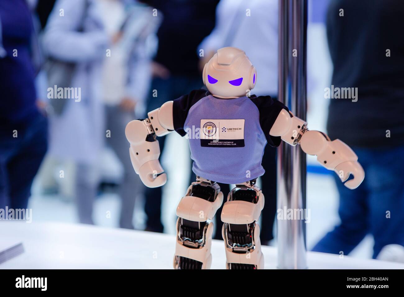Berlin, Germany - September 2017: white small Ubtech robot humanoid on blue crowded background, future technologies, AI Stock Photo