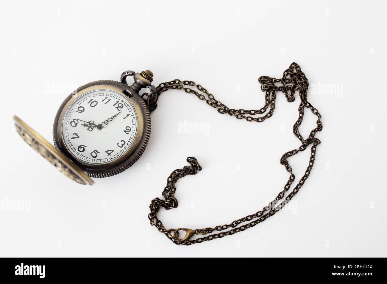 Vintage pocket watch on a chain on a white background. Copy space Stock