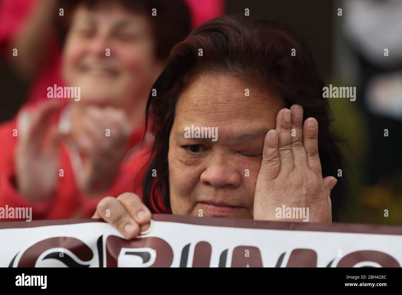 A health care worker becomes emotional as pipers from the Bessbrook Crimson Arrow Pipe Band play outside Daisy Hill Hospital in Newry, Northern Ireland, to salute local heroes during Thursday's nationwide Clap for Carers initiative to recognise and support NHS workers and carers fighting the coronavirus pandemic. Stock Photo