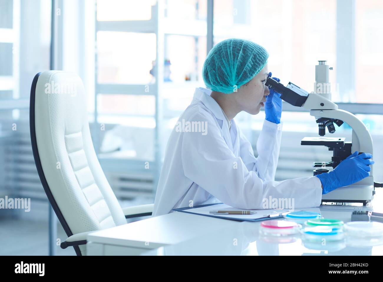 Asian lab technician on microscope hi-res stock photography and images ...