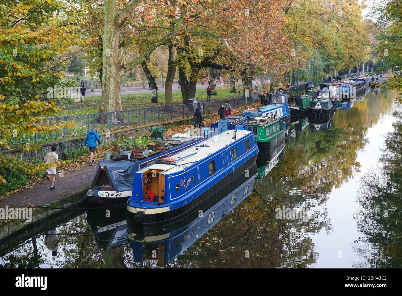 People enjoy autumn weather at Regent's Canal near Victoria Park, London England United Kingdom