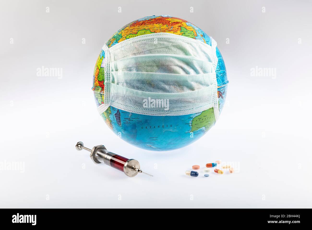 Global pandemic. Coronavirus outbreak. World globe in medical mask. Shopping cart with pills. Coronavirus quarantine. Coronavirus spread on world. Pro Stock Photo