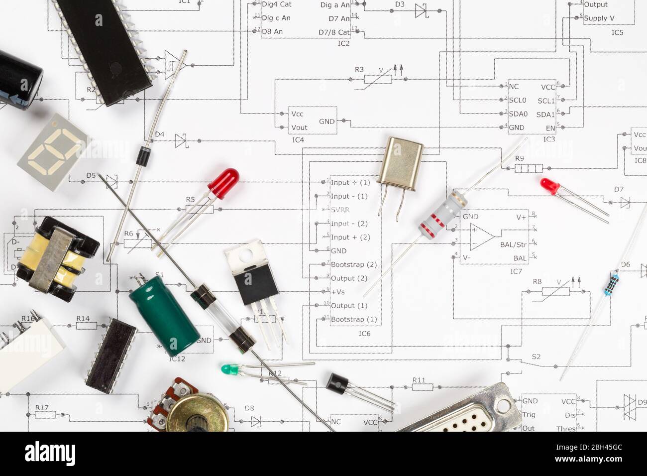 Different electronic parts or components on pcb wiring scheme background with resistors, capacitors, diode and ic chips, flat lay top view from above Stock Photo