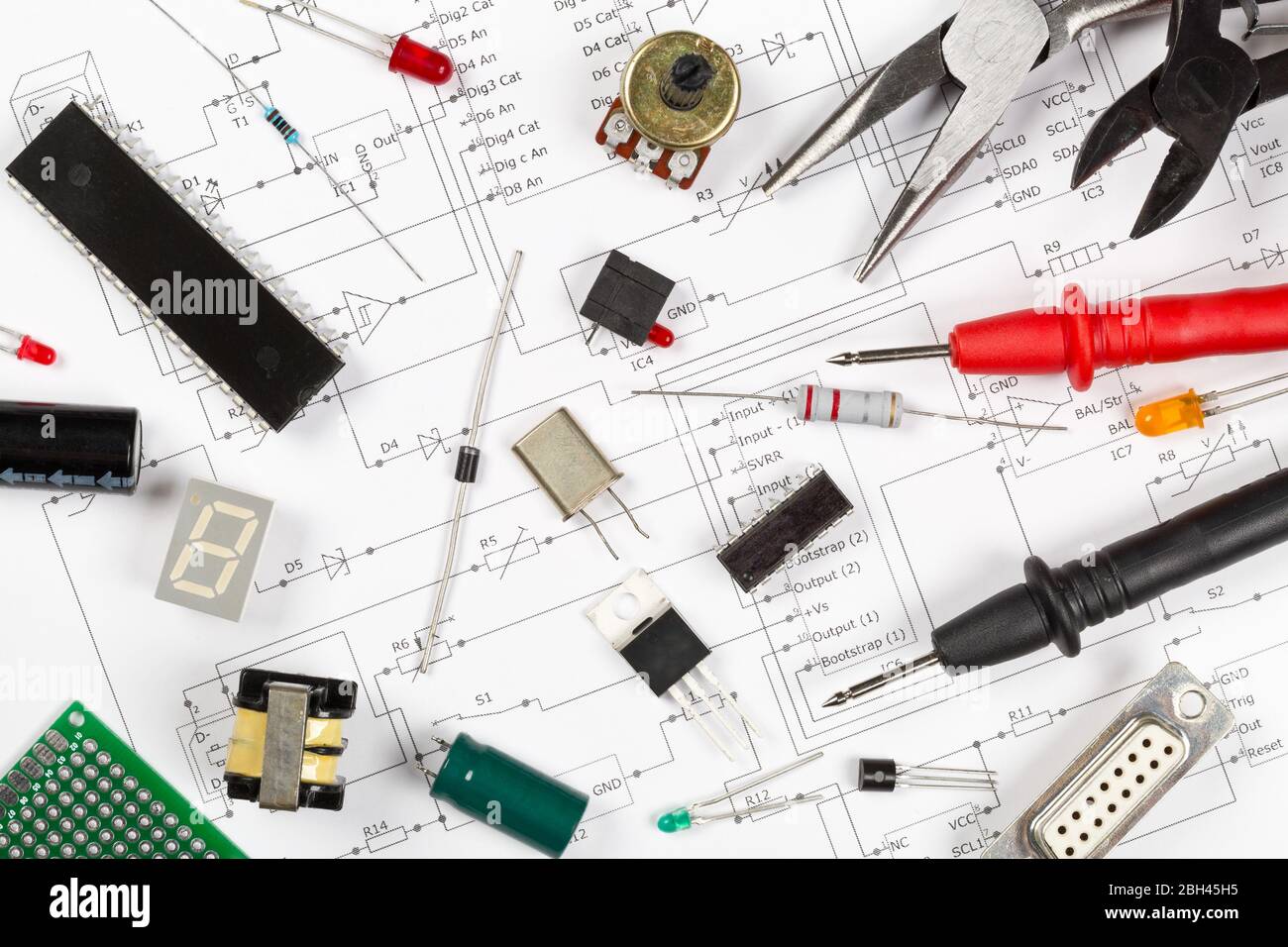 Different electronic parts or components on pcb wiring scheme background with resistors, capacitors, diode and ic chips, flat lay top view from above Stock Photo