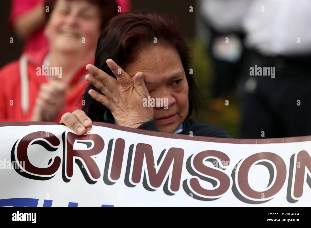 A health care worker becomes emotional as the Bessbrook Crimson Arrow Pipe Band plays for staff outside Daisy Hill Hospital in Newry, Northern Ireland, to salute local heroes during Thursday's nationwide Clap for Carers initiative to recognise and support NHS workers and carers fighting the coronavirus pandemic. Stock Photo
