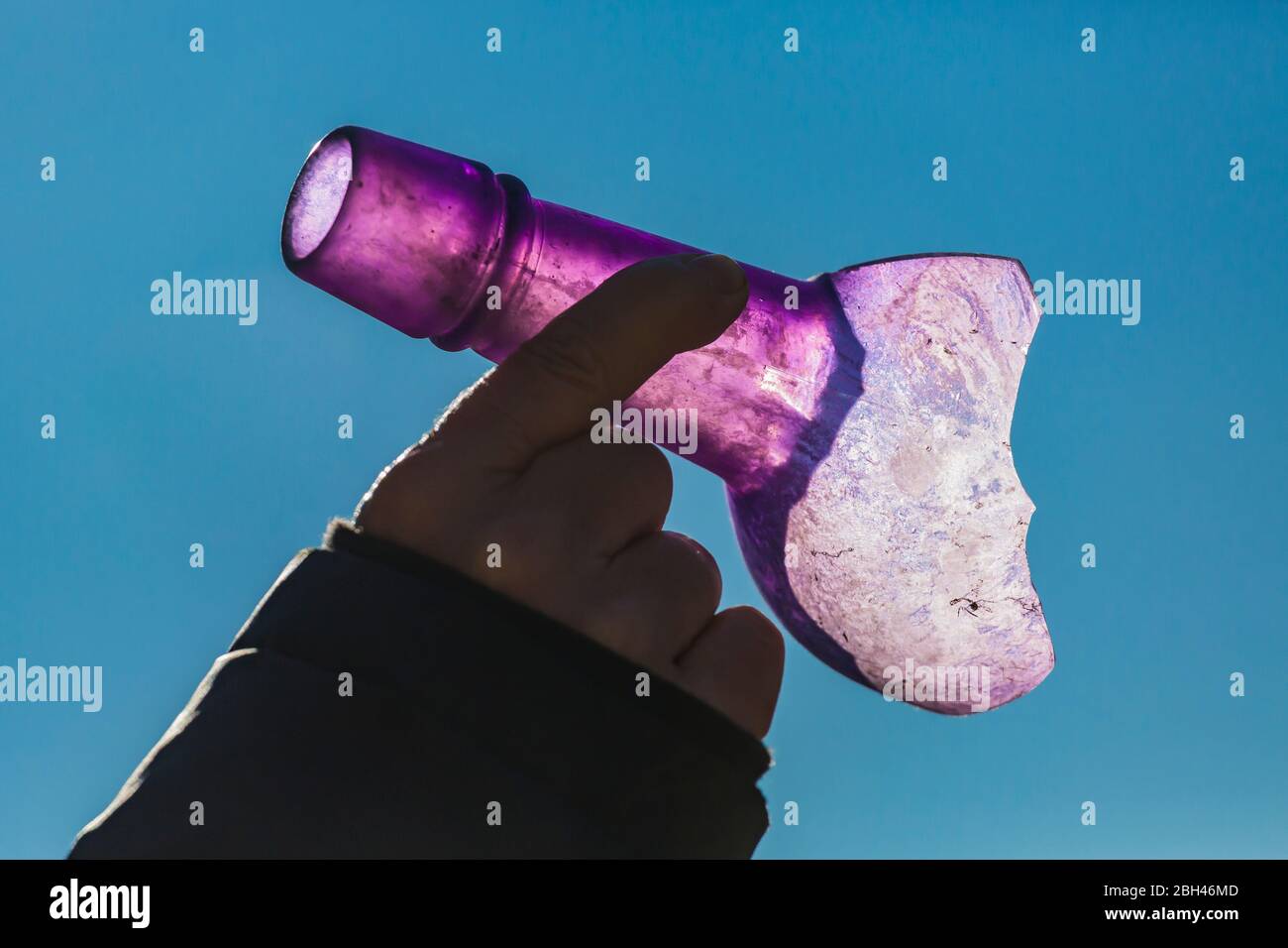 Old glass bottle neck turned purple by the UV rays in sunlight in the old silver and gold mining ghost town of Berlin in Berlin-Ichthyosaur State Park Stock Photo