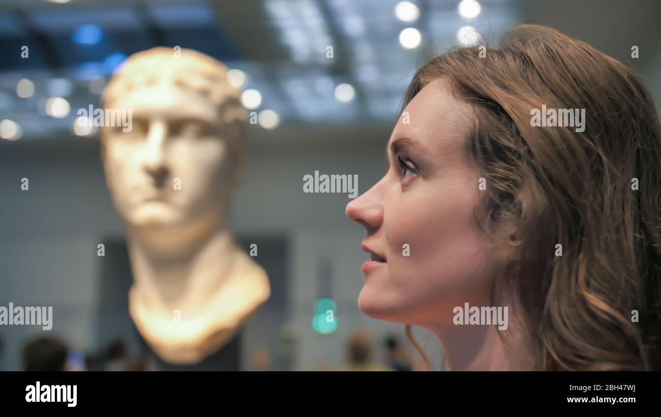 A young girl looks at exhibits in a museum Stock Photo - Alamy