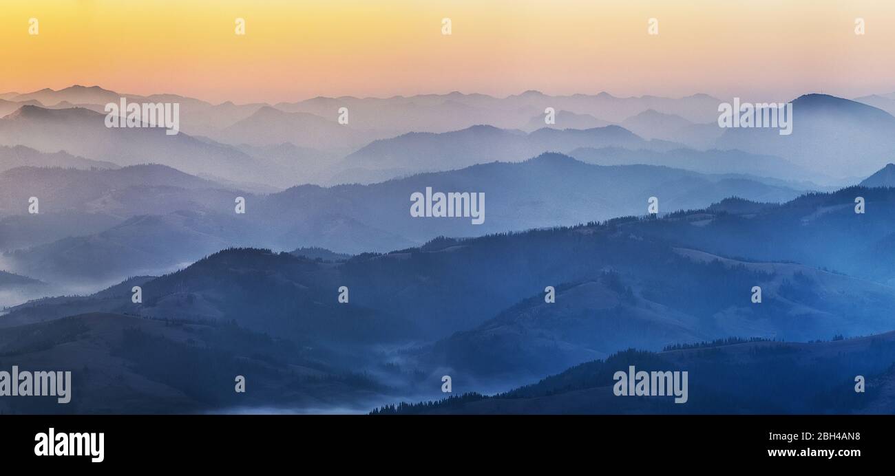 Predawn time in the highlands. mountain silhouettes in the fog Stock Photo