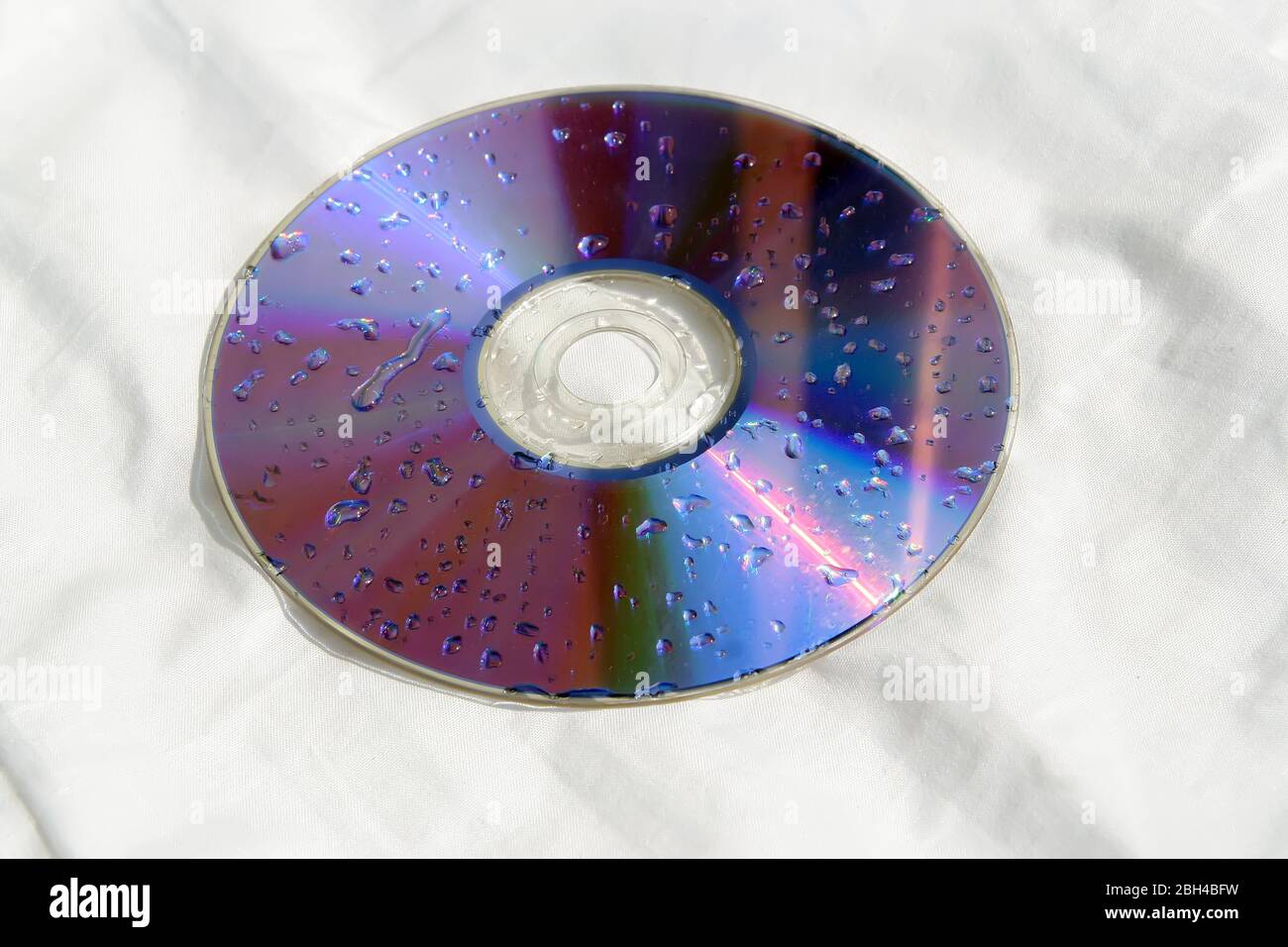 Wet CD disc. Wet DVD disc. Raindrops on disc Stock Photo Alamy