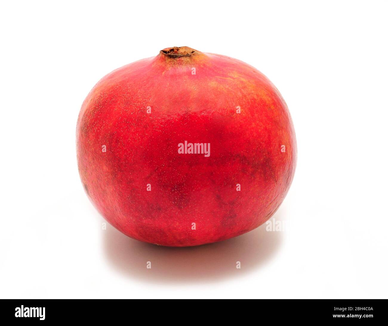 Whole fresh pomegranate on white background. Stock Photo