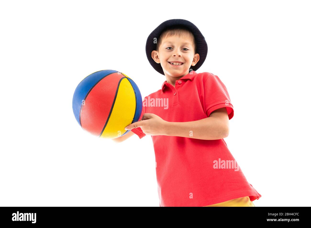 Pretty teenager boy in dark tshirt, jacket with a ball isolated on