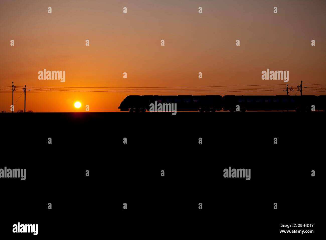 Virgin Trains / Avanti west coast 221 diesel voyager train on the electrified west coast mainline making a sunset silhouette Stock Photo