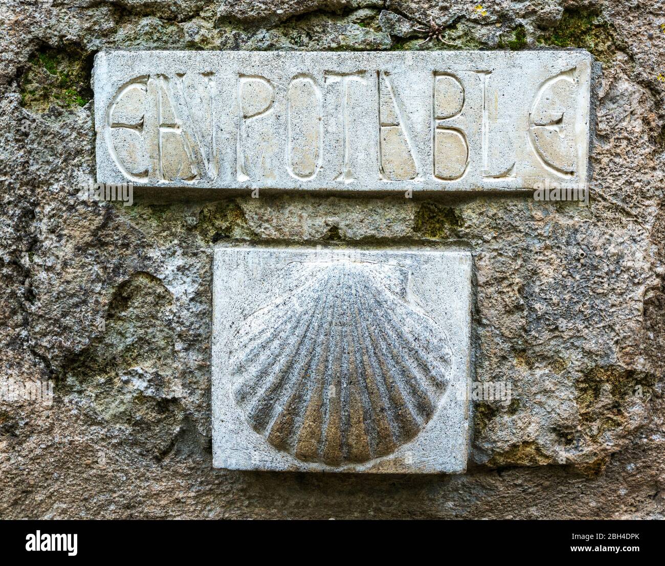 France, Saint-Guilhem-le-Desert, scallop shell  marks a potable water fountain on the route of St. James (Jacques) to Santiago de Compostella Stock Photo
