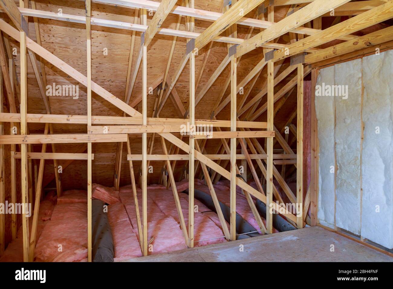 Fiberglass cold barrier insulation material in the sloping attic of a