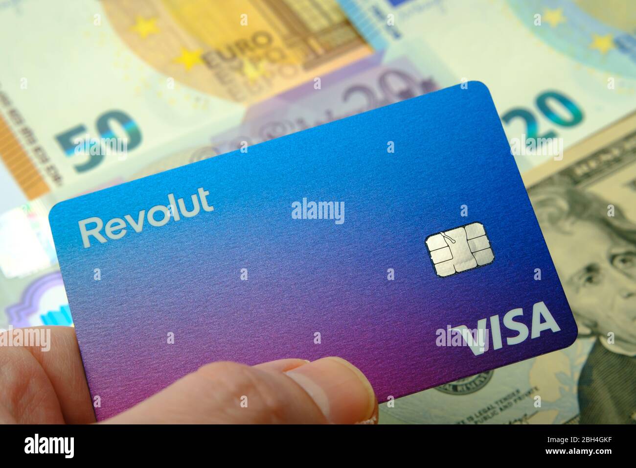Stone / United Kingdom - April 14 2020: The new redesigned Revolut card  hold in a hand. Brand new Revolut Bank card and blurred cash on the  background Stock Photo - Alamy